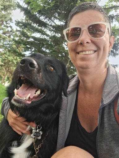 Blue Leah with blue, a large black dog